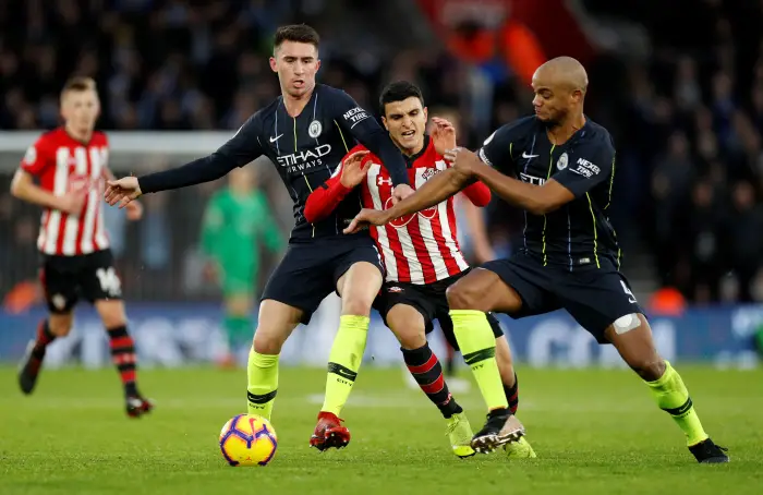 Soccer Football - Premier League - Southampton v Manchester City - St Mary's Stadium, Southampton, Britain - December 30, 2018  Southampton's Mohamed Elyounoussi in action with Manchester City's Aymeric Laporte and Vincent Kompany