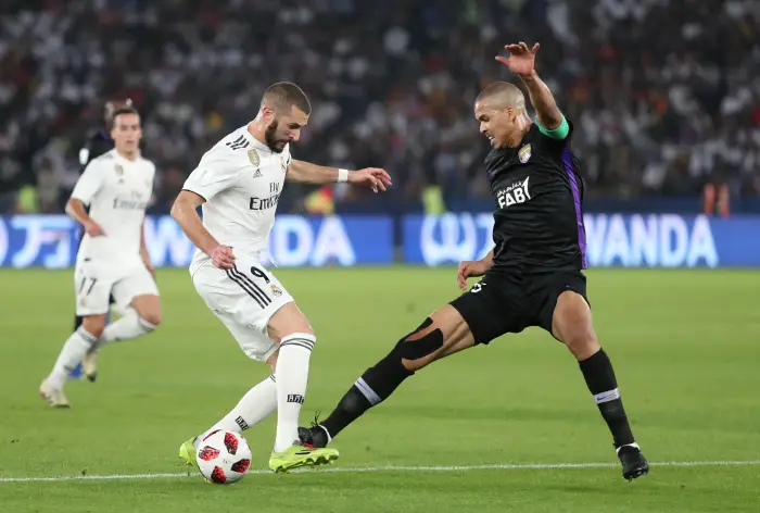 Real Madrid's Karim Benzema in action with Al-Ain's Ismail Ahmed