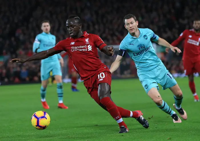 29th December 2018, Anfield, Liverpool, England; EPL Premier League football, Liverpool versus Arsenal; Sadio Mane of Liverpool takes the ball past Stephan Lichtsteiner of Arsenal