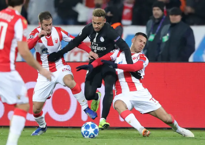 Paris St Germain's Neymar in action with Crvena Zvezda's Marko Gobeljic and Goran Causic