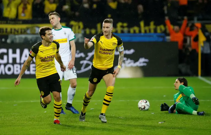 Borussia Dortmund's Marco Reus celebrates scoring their second goal with Raphael Guerreiro