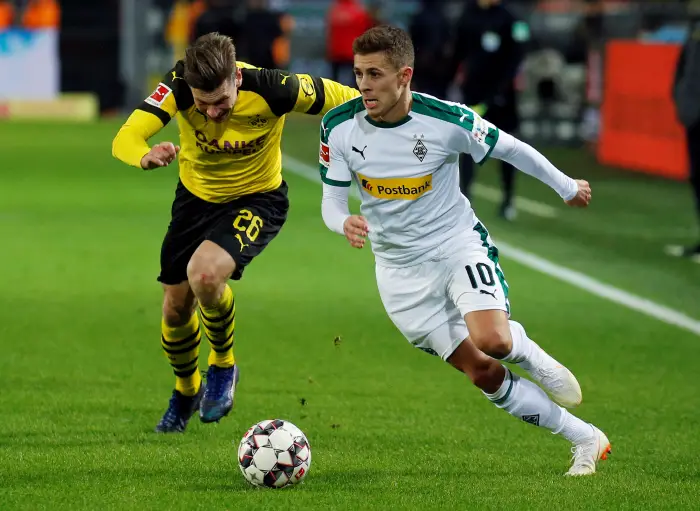 Borussia Monchengladbach's Thorgan Hazard in action with Borussia Dortmund's Lukasz Piszczek