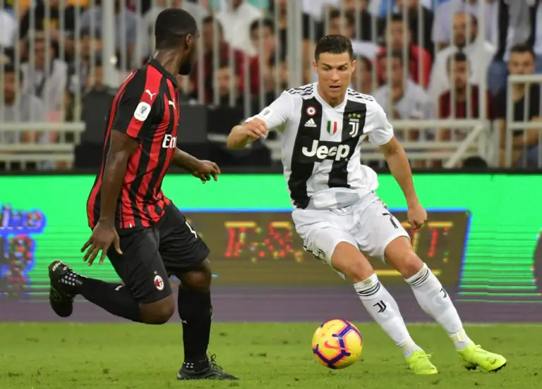 Juventus' Portuguese forward Cristiano Ronaldo (R) is marked by AC Milan's Colombian defender Cristian Zapata during their Supercoppa Italiana final between Juventus and AC Milan at the King Abdullah Sports City Stadium in Jeddah on January 16, 2019. (Photo by GIUSEPPE CACACE / AFP)