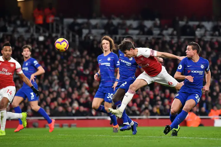 Arsenal's French defender Laurent Koscielny (2nd R) has this header saved during the English Premier League football match between Arsenal and Cheslea at the Emirates Stadium in London on January 19, 2019. (Photo by Ben STANSALL / AFP) / RESTRICTED TO EDITORIAL USE. No use with unauthorized audio, video, data, fixture lists, club/league logos or 'live' services. Online in-match use limited to 120 images. An additional 40 images may be used in extra time. No video emulation. Social media in-match use limited to 120 images. An additional 40 images may be used in extra time. No use in betting publications, games or single club/league/player publications. /