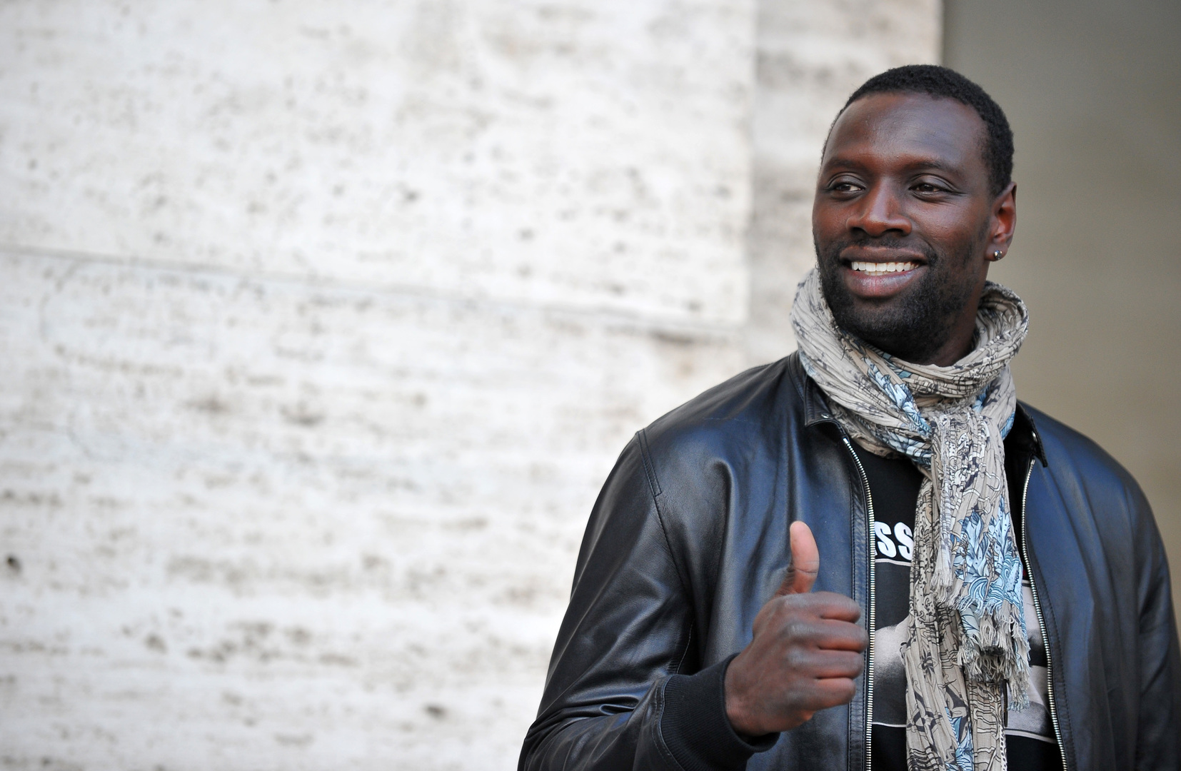 French actor Omar Sy poses during the photocall of the movie ''De l'autre cote du periph'' in Rome on March 21, 2013.  AFP PHOTO / TIZIANA FABI