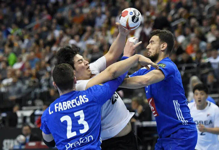 Korea's Kwangsoon Park in action with France's Ludovic Fabregas and Nedim Remili