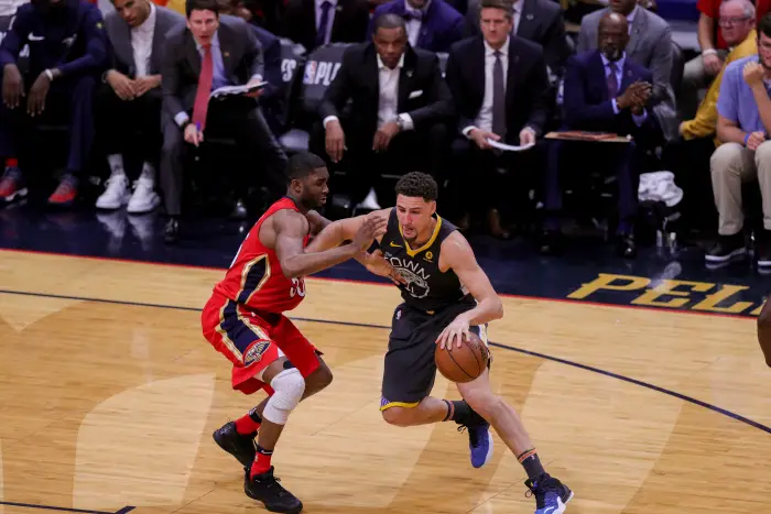 Golden State Warriors guard Klay Thompson (11) dribbles against New Orleans Pelicans forward E'Twaun Moore (55)