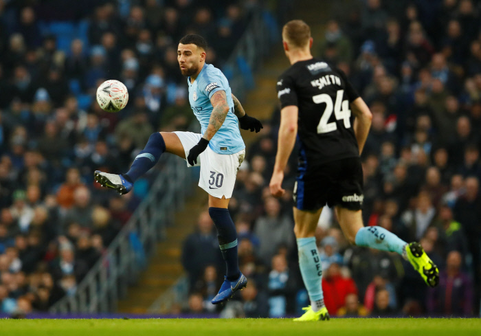 Manchester City's Nicolas Otamendi in action with Rotherham United's Michael Smith