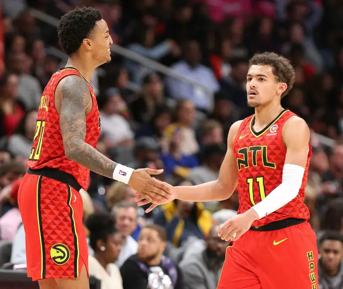 Atlanta Hawks guard Trae Young gets five from John Collins in the final minutes of a 106-82 victory over the Miami Heat on Sunday, Jan. 6, 2019 at State Farm Arena in Atlanta, Ga.
