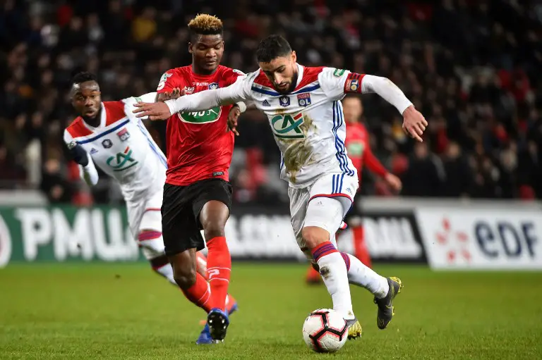 Guingamp's French midfielder Ludovic Blas (2nd L) fights for the ball with Lyon's French forward Nabil Fekir (R) during the French Cup round of 16 football match between Guingamp (EAG) and Lyon (OL), on February 7, 2019, at Roudourou Stadium, in Guingamp, western France. (Photo by JEAN-FRANCOIS MONIER / AFP)
