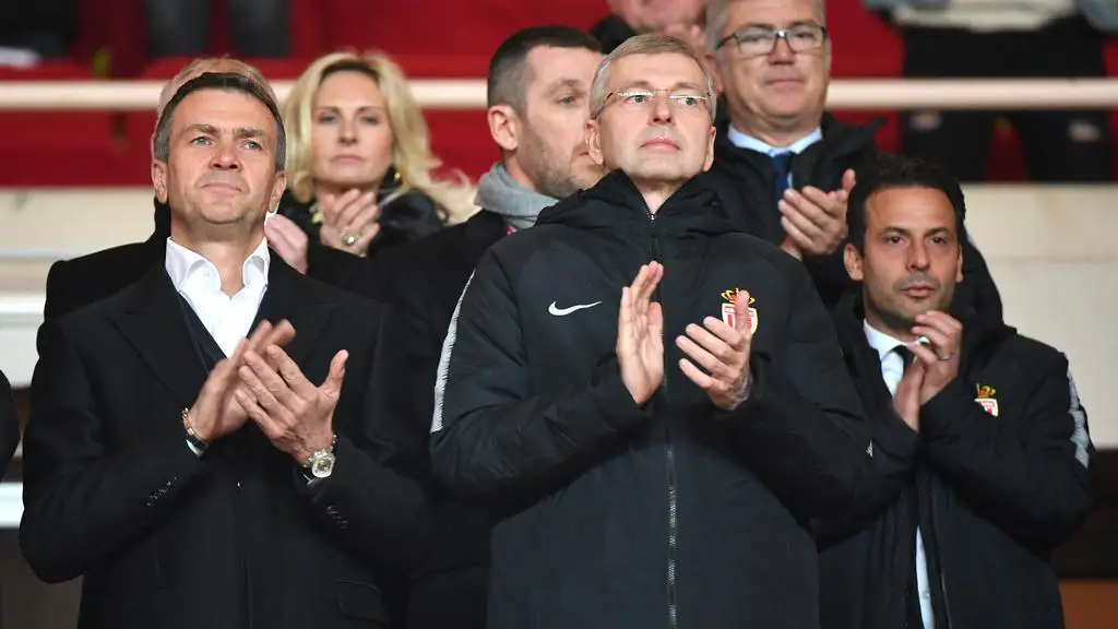 (FILES) This file photo taken on February 16, 2019 at Louis II stadium in Monaco shows Monaco's Russian president Dmitri Rybolovlev (C) Russian businessman Oleg Petrov (L) and AS Monaco ambassador Ludovic Giuly (R) applauding. - Oleg Petrov was appointed the club new general director, the club's management announced on February 22, 2019. (Photo by YANN COATSALIOU / AFP)