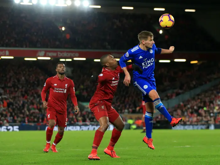 Marc Albrighton of Leicester City heads a clearance under pressure from Daniel Sturridge of Liverpool