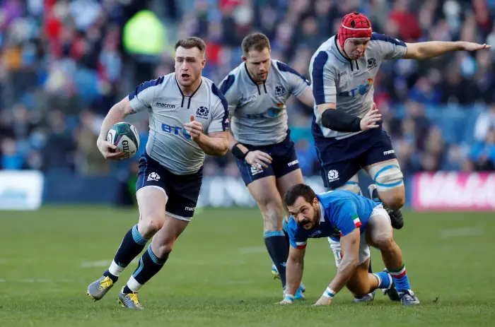 Scotland's Stuart Hogg gets away from Italy's Tito Tebaldi