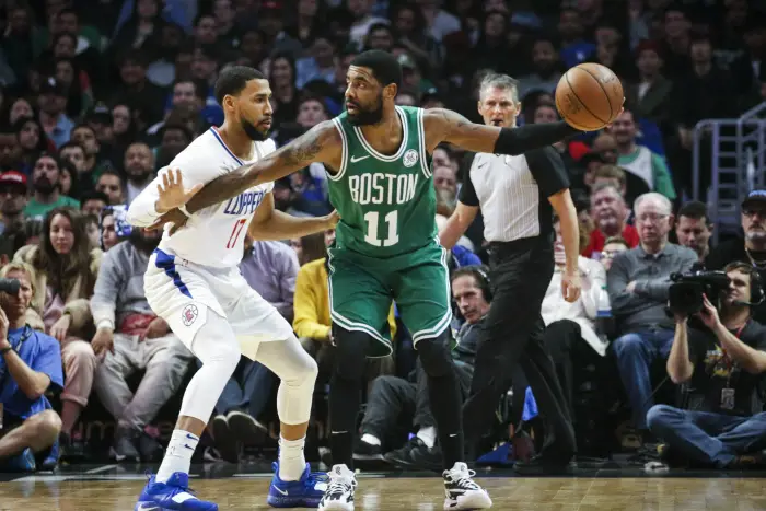 Boston Celtics' Kyrie Irving (11) dribbles against Los Angeles Clippers  Garrett Temple (17)