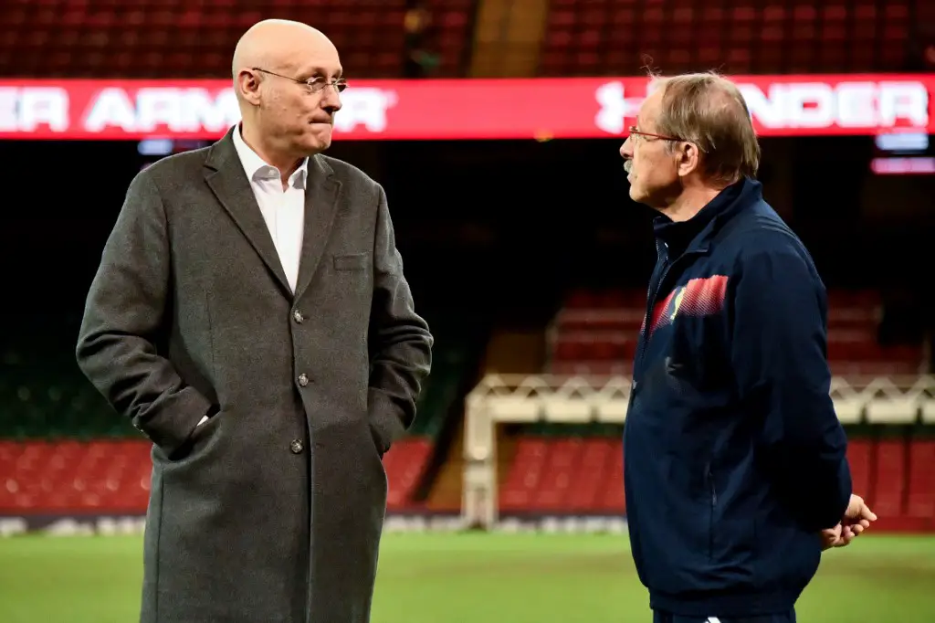 French rugby team coach Jacques Brunel (R) chats with Bernard Laporte, French president of the rugby federationan, before the captain run at the Millenium stadium, in Cardiff on March 16, 2018, on the eve of their game against wales. (Photo by Christophe SIMON / AFP)