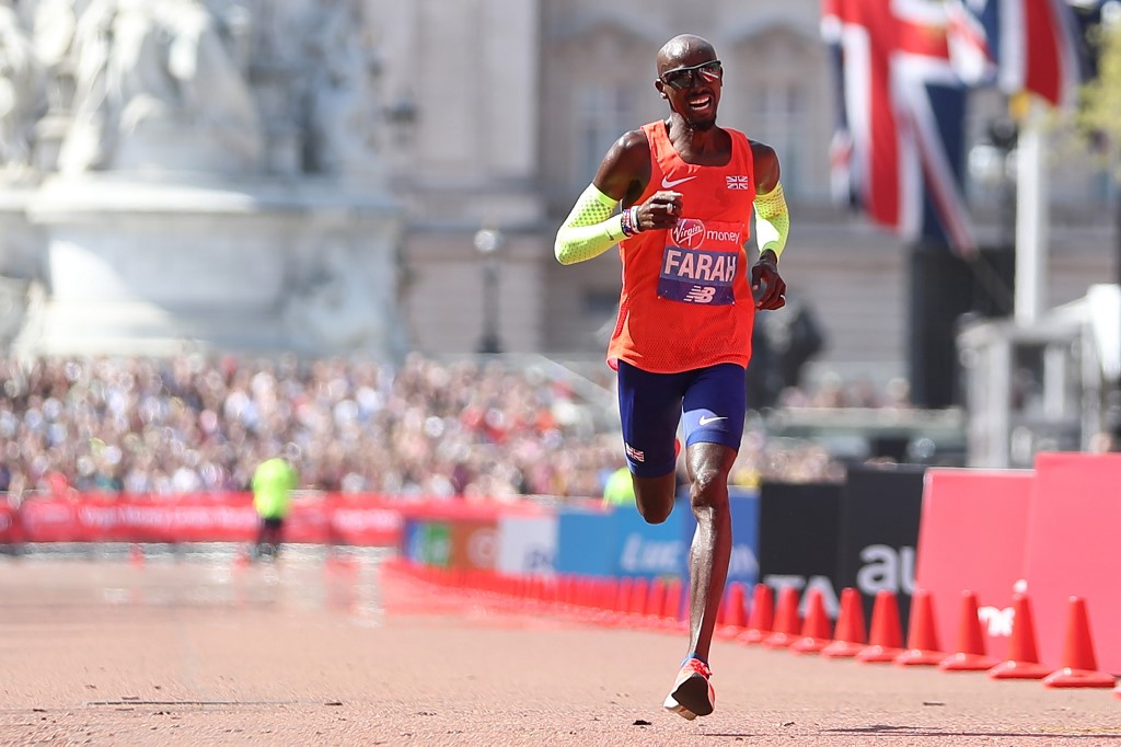 Third-placed Britain's Mo Farah crosses the finish line of the elite men's race of the 2018 London Marathon in central London on April 22, 2018. (Photo by Daniel LEAL-OLIVAS / AFP)