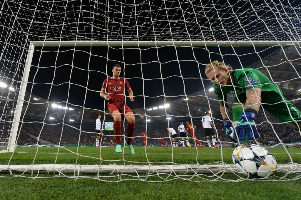 Roma's Bosnian striker Edin Dzeko (L) enters the goal as Liverpool's German goalkeeper Loris Karius picks up the ball after a Liverpool's own goal during the UEFA Champions League semi-final second leg football match AS Roma vs Liverpool FC at the Stadio Olimpico in Rome on May 2, 2018. (Photo by Alberto PIZZOLI / AFP)