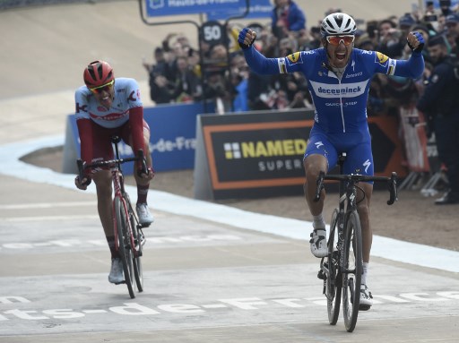 Belgium's Philippe Gilbert (R) celebrates his victory as he crosses the finish line past Germany's Nils Politt during the 117th edition of the Paris-Roubaix one-day classic cycling race, between Compiegne and Roubaix, in Roubaix, northern France on April 14, 2019. (Photo by FRANCOIS LO PRESTI / AFP)