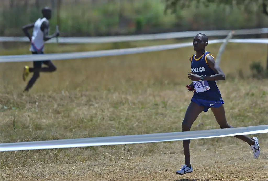 World 1,500m champion Asbel Kiprop runs to win the cross-country mixed relays for the Kenya Police team on February 18, 2017 in the Kenyan capital, Nairobi during qualifiers for the national team to the  IAAF World Cross Country Championships. - Leonard Barsoton and Irene Cheptai will head a 24-member Kenyan team at the 2017 World Cross-country championships in Kampala, Uganda on March 26, after winning the national trials. (Photo by TONY KARUMBA / AFP)