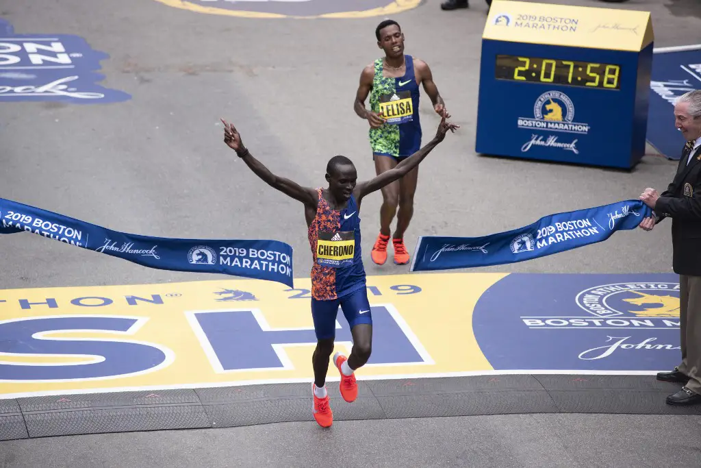 Kenyan Lawrence Cherono edges Ethopian Lelisa Desisa for first place for the Men's Elite race, at the 123rd Boston Marathon on April 15, 2019 in Boston, Massachusetts. - Kenya's Lawrence Cherono sprinted to victory in the Boston Marathon on Monday, overhauling Ethiopia's Lelisa Desisa in the final few metres of the gruelling race to claim a thrilling win. In damp, chilly conditions, Cherono, Desisa and Kenya's Kenneth Kipkemoi broke away from the field over the final few miles as the world's oldest major marathon reached a dramatic conclusion. Desisa, the 2013 World Champion and two-time Boston Marathon champion, looked to be on course for victory as he kicked for home in the final 200m.But with the crowds at Boston's famous Boylston Street finish line roaring them on, it was Cherono who timed his finish to perfection, overhauling the grimacing Desisa just a few metres from the tape to claim a magnificent win in 2hr 7min 57 sec. (Photo by RYAN MCBRIDE / AFP)