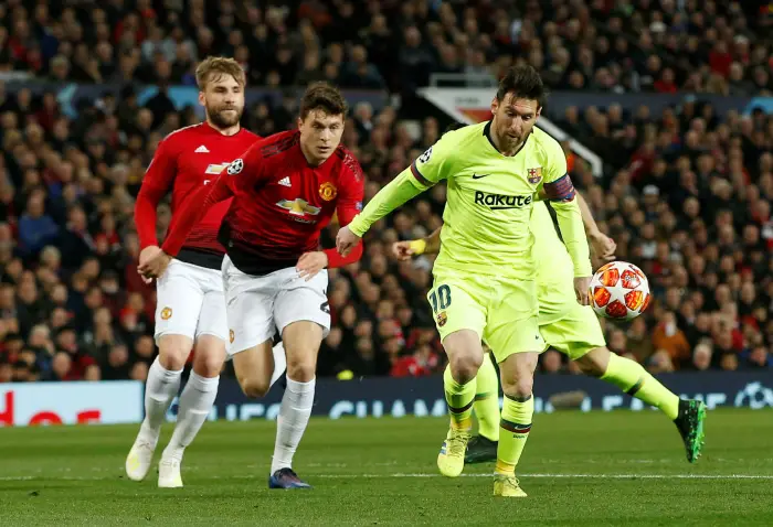 Barcelona's Lionel Messi in action with Manchester United's Victor Lindelof and Luke Shaw