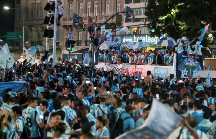 Racing Club players and staff celebrate with fans after winning the Superliga title in downtown Buenos Aires, Argentina - March 31, 2019