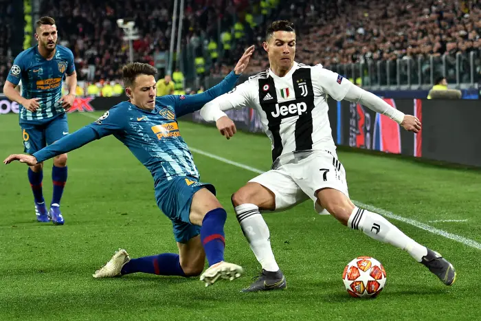 Santiago Arias of Atletico Madrid and Cristiano Ronaldo of Juventus compete for the ball
