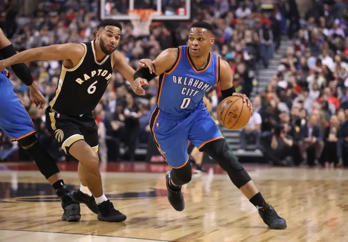 Oklahoma City Thunder point guard Russell Westbrook (0) goes to the basket past Toronto Raptors point guard Cory Joseph (6)