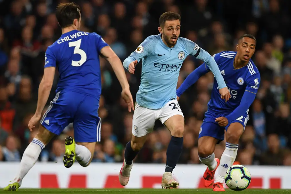 Manchester City's Portuguese midfielder Bernardo Silva (C) takes on Leicester City's English defender Ben Chilwell (L) during the English Premier League football match between Manchester City and Leicester City at the Etihad Stadium in Manchester, north west England, on May 6, 2019. (Photo by Paul ELLIS / AFP) / RESTRICTED TO EDITORIAL USE. No use with unauthorized audio, video, data, fixture lists, club/league logos or 'live' services. Online in-match use limited to 120 images. An additional 40 images may be used in extra time. No video emulation. Social media in-match use limited to 120 images. An additional 40 images may be used in extra time. No use in betting publications, games or single club/league/player publications. /