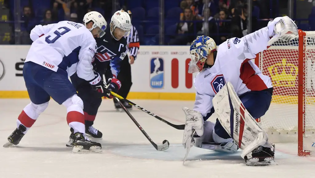 United States' forward Patrick Kane (C) scores past France's defender Jonathan Janil (L) and France's goalkeeper Sebastian Ylonen (R) during the IIHF Men's Ice Hockey World Championships Group A match between the US and France on May 12, 2019 in Kosice, Slovakia. (Photo by JOE KLAMAR / AFP)