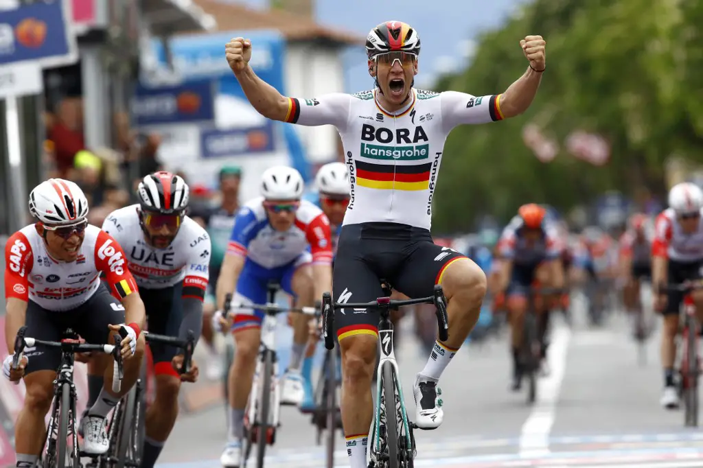 Team Bora rider Germany's Pascal Ackermann jubilates as he finishes first the second stage of the 2019 Giro d'Italia, the cycling Tour of Italy, on May 12, 2019 in Fucecchio. - German champion Pascal Ackermann won a high speed bunch sprint to claim victory on stage two of the Giro d'Italia on May 12, edging home favourite at the line. (Photo by Luk BENIES / AFP)