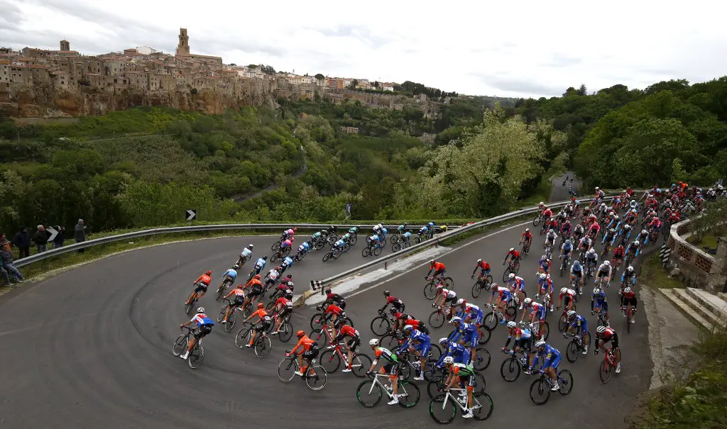 The peloton rides past Pitigliano during the stage four of the 102nd Giro d'Italia - Tour of Italy - cycle race, 235kms from Orbetello to Frascati on May 14, 2019. (Photo by Luk BENIES / AFP)