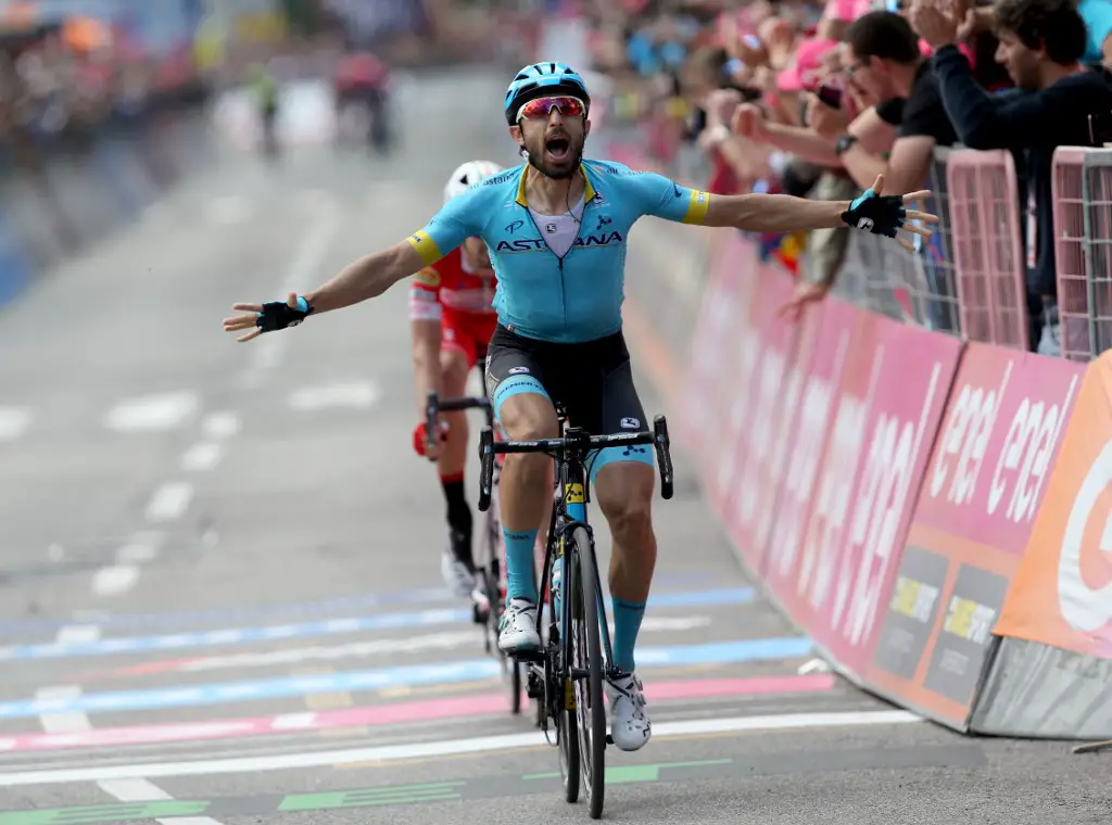 Team Astana rider Italy's Dario Cataldo celebrates as he crosses the finish line in the stage fifteen of the 102nd Giro d'Italia - Tour of Italy - cycle race, 232kms from Ivrea to Como on May 26, 2019. (Photo by Luk BENIES / AFP)