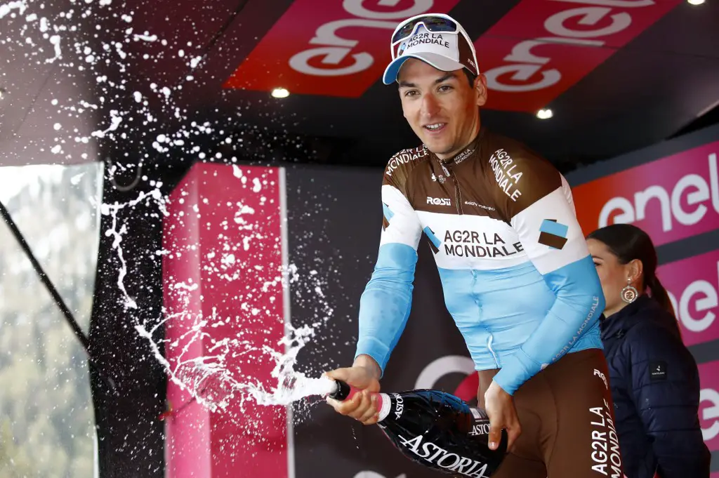 Team AG2R La Mondiale rider France's Nans Peters sprays champagne as he celebrates his victory during the podium ceremony after the stage seventeen of the 102nd Giro d'Italia - Tour of Italy - cycle race, 181kms from Commezzadura to Anterselva/Antholz on May 29, 2019. (Photo by Luk BENIES / AFP)