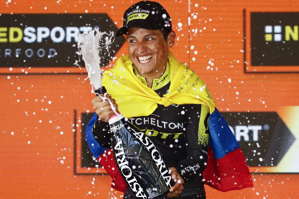 Team Mitchelton rider Colombia's Esteban Chaves sprays champagne as he celebrates on the podium after winning stage nineteen of the 102nd Giro d'Italia - Tour of Italy - cycle race, 151kms from Treviso to San Martino di Castrozza on May 31, 2019. (Photo by Luk BENIES / AFP)