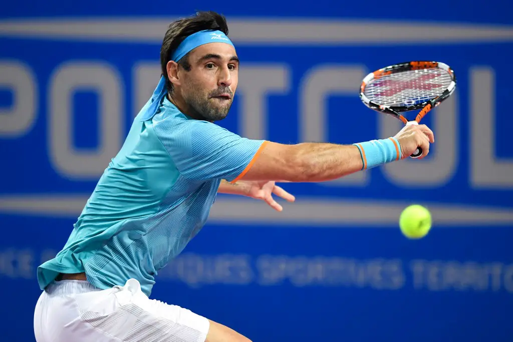 Cyprus' Marcos Baghdatis returns the ball to France's Lucas Pouille during their ATP World Tour Open Sud de France tennis match in Montpellier, southern France, on February 7, 2019. (Photo by PASCAL GUYOT / AFP)