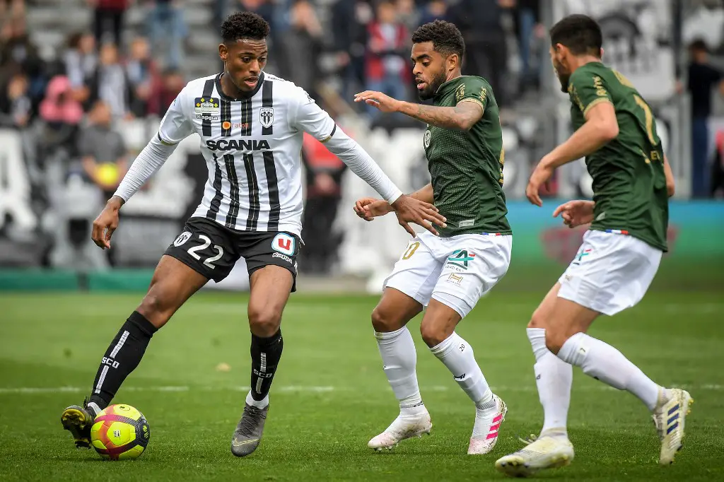 Angers' French midfielder Jeff Reine Adelaide (L) vies with Reims' French midfielder Tristan Dingome during the French L1 football match between Angers SCO and Stade de Reims at the Raymond-Kopa Stadium in Angers, northwestern France on April 28, 2019. (Photo by LOIC VENANCE / AFP)