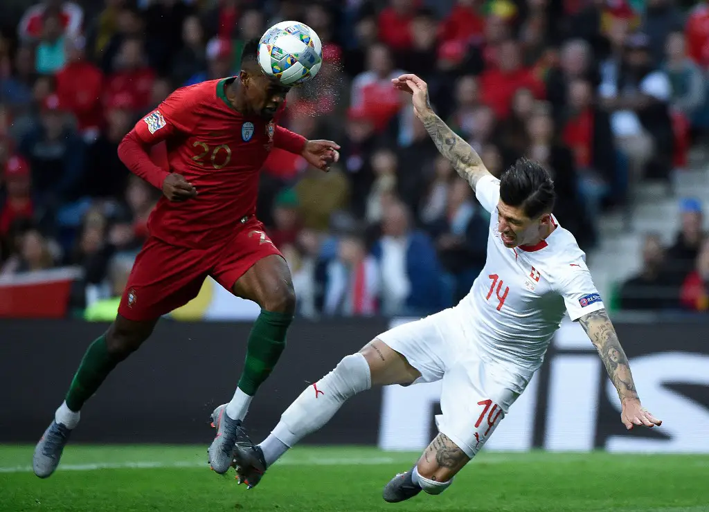 Portugal's defender Nelson Semedo (L) heads the ball past Switzerland's midfielder Steven Zuber (R) during the UEFA Nations League semi-final football match between Portugal and Switzerland at the Dragao stadium in Porto on June 5, 2019. (Photo by MIGUEL RIOPA / AFP)