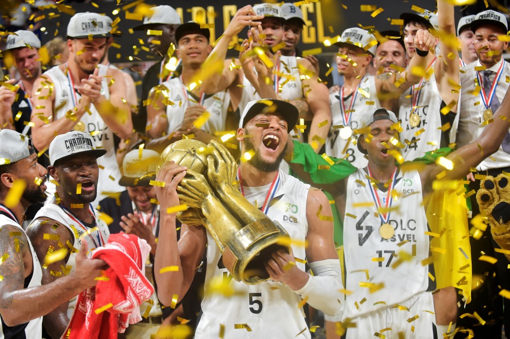 Lyon-Villeurbanne's American center and power forward Adreian Payne (C) holds the trophy as he celebrates with teammates during the 5th leg of the French Elite championship final basketball match between Monaco (AS Monaco) and Villeurbanne (ASVEL) at the Astroballe arena in Villeurbanne, on June 25, 2019. (Photo by ROMAIN LAFABREGUE / AFP)