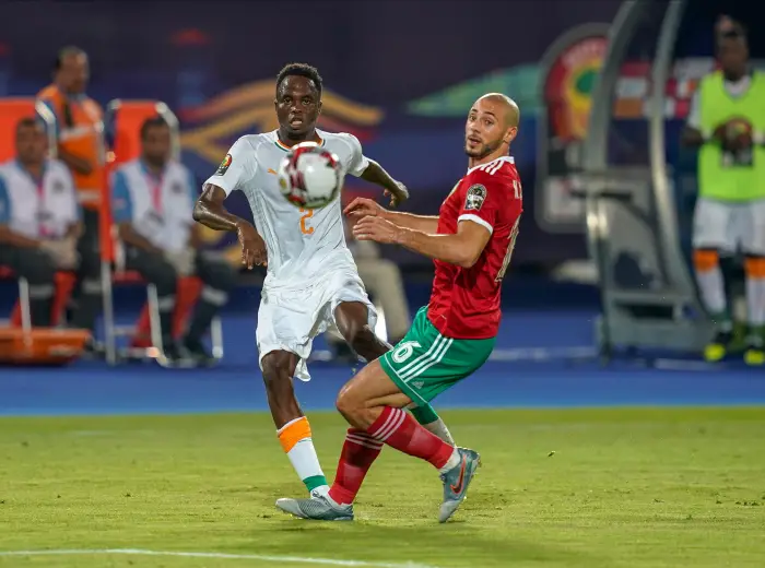 Wonlo Coulibaly of Cote  D ivoire passing the ball in front of Noureddine Amrabat of Morocco