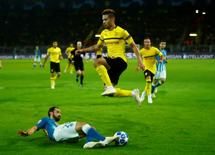 Borussia Dortmund's Raphael Guerreiro in action with Atletico Madrid's Juanfran