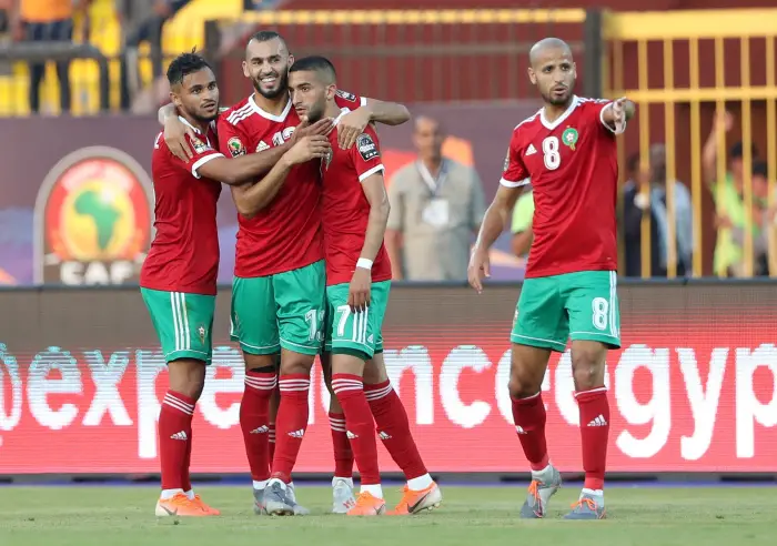 Soccer Football - Africa Cup of Nations 2019 - Group D - Morocco v Namibia - Al Salam Stadium, Cairo, Egypt - June 23, 2019  Morocco's Khalid Boutaib and Hakim Ziyech and team mates celebrate after Namibia's Itamunua Keimuine scored an own goal and Morocco's first