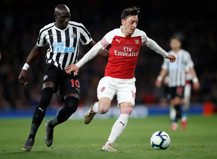 Arsenal's Mesut Ozil in action with Newcastle United's Mohamed Diame