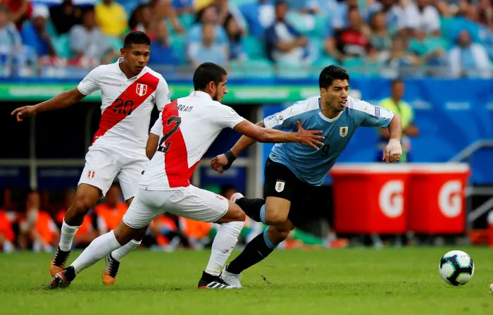 Uruguay's Luis Suarez in action with Peru's Luis Abram Ugarelli