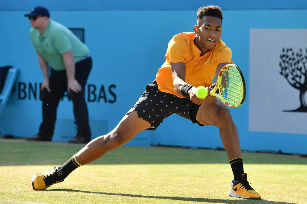 Canada's Felix Auger Aliassime returns to Spain's Feliciano Lopez in their men's singles semi final tennis match at the ATP Fever-Tree Championships tournament at Queen's Club in west London on June 22, 2019. (Photo by Ben STANSALL / AFP)