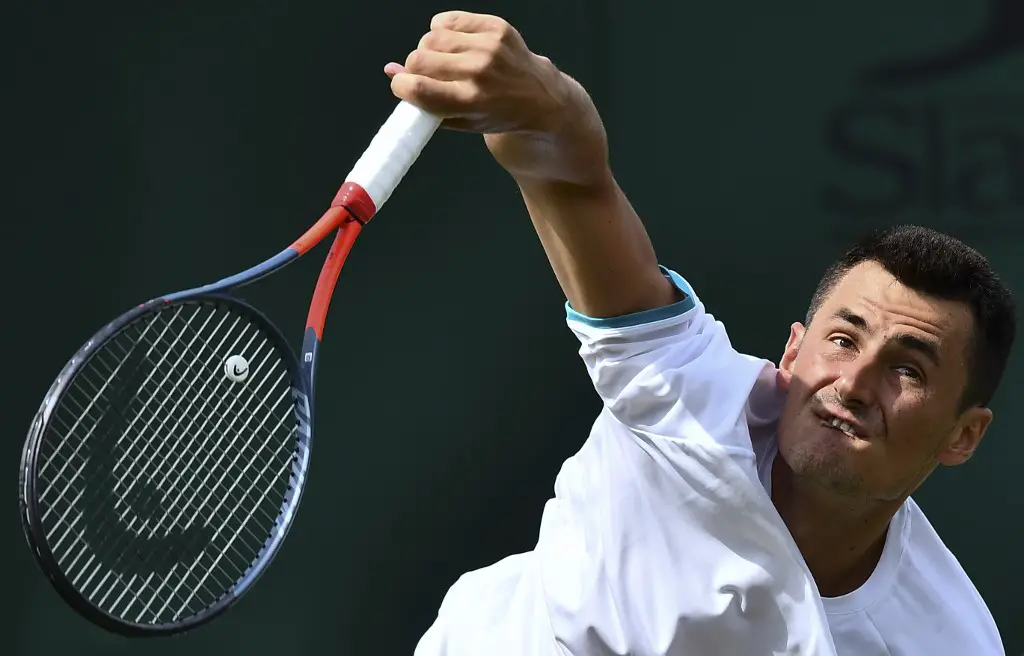 Australia's Bernard Tomic serves against France's Jo-Wilfried Tsonga during their men's singles first round match on the second day of the 2019 Wimbledon Championships at The All England Lawn Tennis Club in Wimbledon, southwest London, on July 2, 2019. (Photo by Ben STANSALL / AFP) / RESTRICTED TO EDITORIAL USE