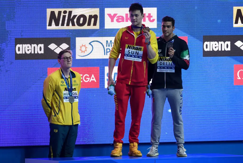 Silver medallist Australia's Mack Horton (L) refuses to stand on the podium with gold medallist China's Sun Yang (C) and bronze medallist Italy's Gabriele Detti after the final of the men's 400m freestyle event during the swimming competition at the 2019 World Championships at Nambu University Municipal Aquatics Center in Gwangju, South Korea, on July 21, 2019. (Photo by Ed JONES / AFP)