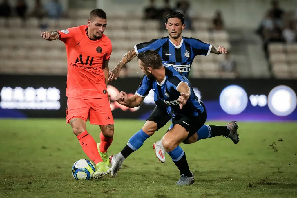 Paris St. Germain's Marco Verratti (L) vies for the ball with Inter Milan's Danilo D'Ambrosio (front) during their International Super Cup football match in Macau on July 27, 2019. (Photo by VIVEK PRAKASH / AFP)