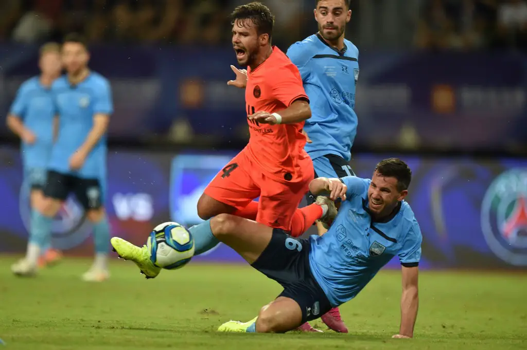 Paris Saint Germain's Juan Bernat (L) fights for the ball with Sydney FC's Ryan Mc Gowan at Suzhou Olympic Sports Center Stadium during the International Super Cup in Suzhou, Jiangsu province on July 30, 2019. (Photo by HECTOR RETAMAL / AFP)