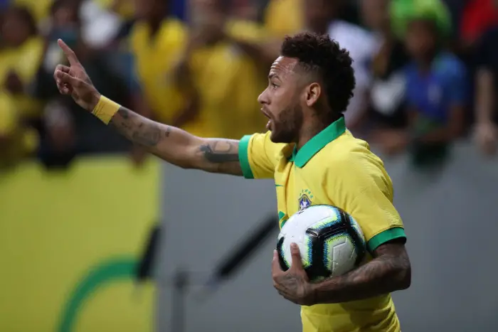 Neymar of Brazil appeals to the referee for a decision holding the ball